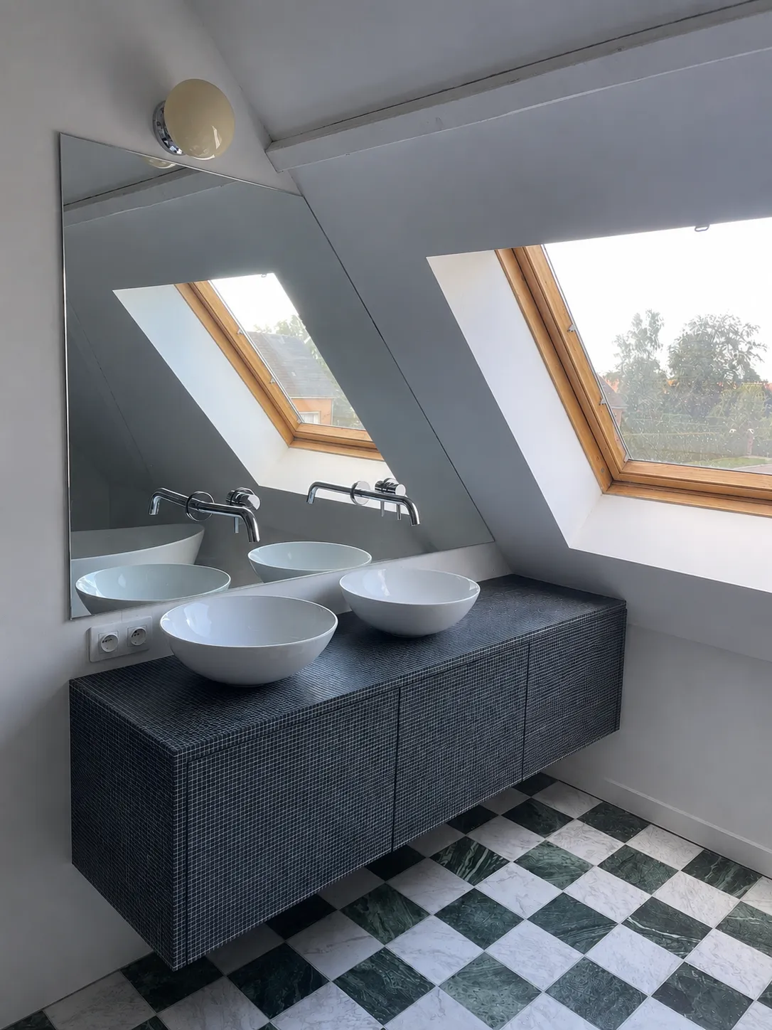 Gerenoveerde badkamer met dubbel lavabomeubel onder de dakramen